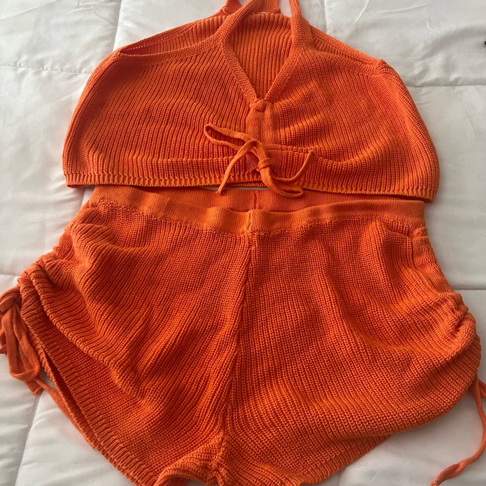 Orange crochet top with shorts with draw strings to match.